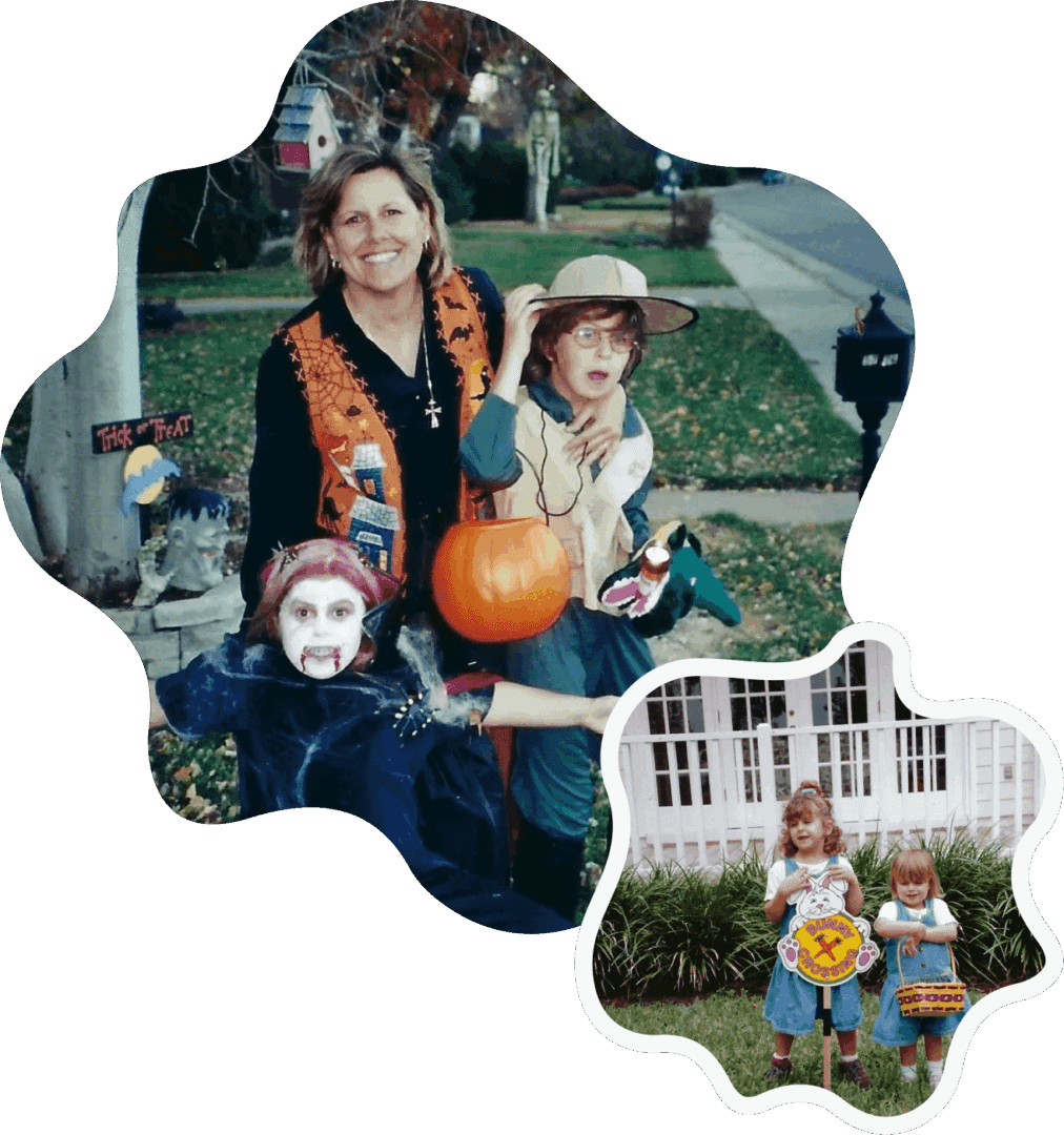 A family in Halloween costumes posing outdoors with pumpkins.