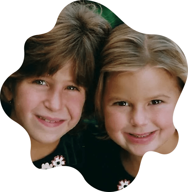 Two smiling children with brown hair.