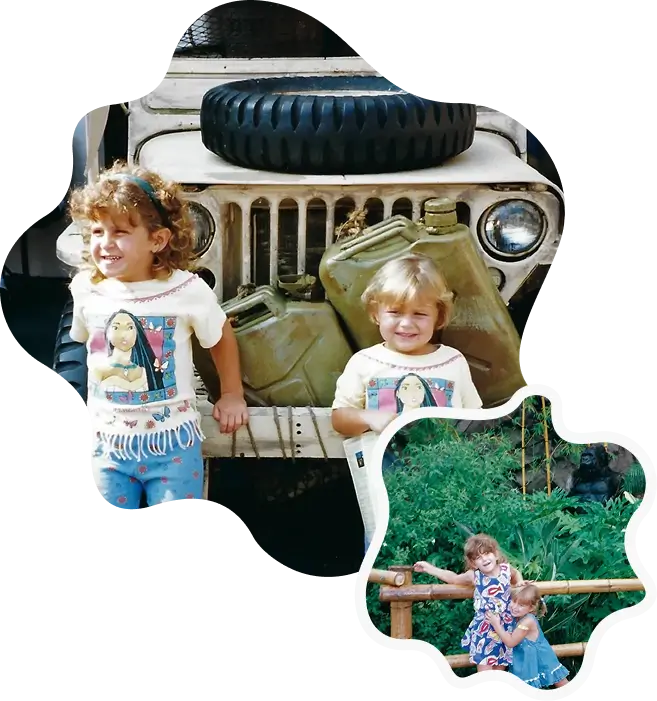 Two children smiling beside vintage military jeep